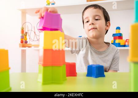 The building blocks of my future. An interested pre-school child building something with plastic blocks. Stock Photo