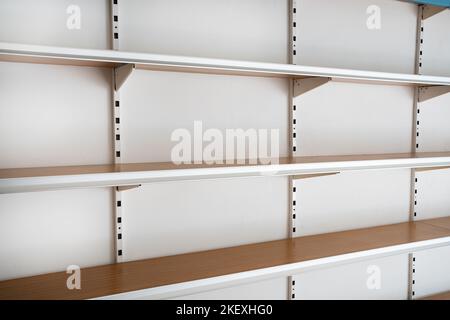 Side view empty supermarket shelves from the front on white Stock Photo
