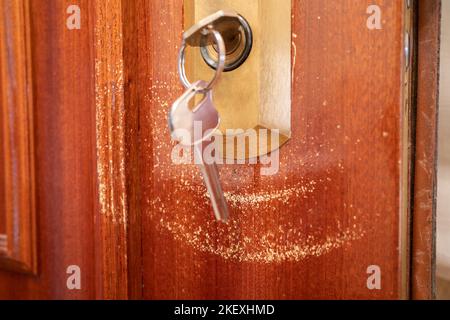Close up of an external lock on a door scratched by keys Stock Photo