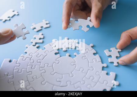 Businessman hand connecting jigsaw puzzle, Business solutions, target, success, goals and strategy concepts Stock Photo