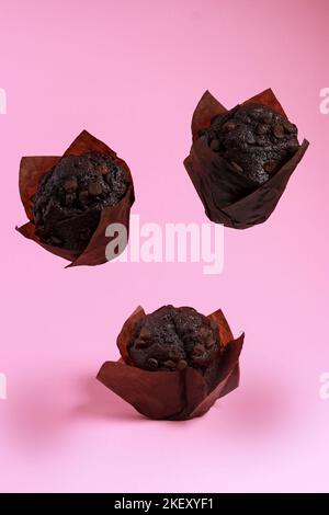 levitation of chocolate chip muffins isolated on pink background  Stock Photo