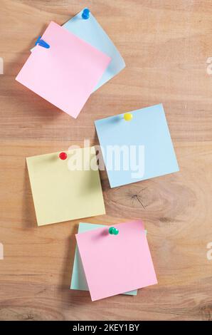Paper sticky notes on wooden board close up Stock Photo