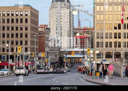 Ottawa, Canada - November 5, 2022: Busy Rideau street in downtown district. Cityscape with intersection, traffic lights, and walking people. Stock Photo