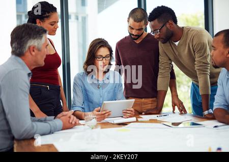 Sharing ideas have never been easier. a group of architects in the boardroom. Stock Photo