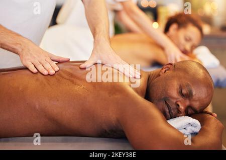 Skincare, massage and physiotherapy hands for zen couple in spa for wellness, relax or health. Salon, luxury and black man and woman enjoy treatment Stock Photo