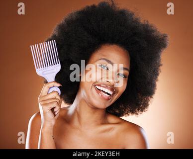 Beauty, hair and afro and black woman and comb for self care, natural and freedom. Happy, smile and untangling with portrait of African girl model and Stock Photo