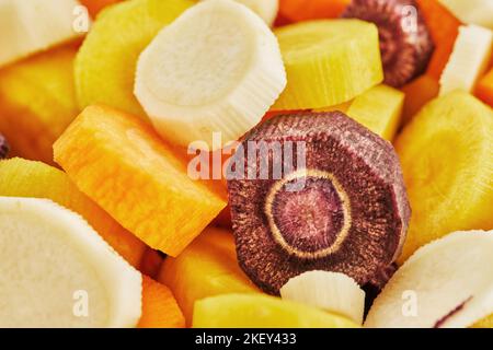 Carrots of three colors sliced into slices in bowl are ready for cooking Stock Photo