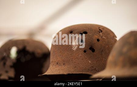 rusty and with bullet holes German World War Two (Stahlhelm M1942) military helmet, battle of Normandy 1944 Stock Photo