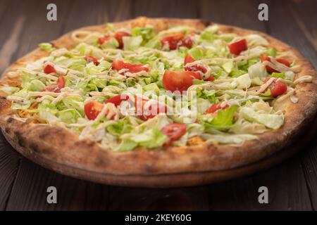 Delicious Pizza Caesar with Parmesan cheese on wooden table Stock Photo