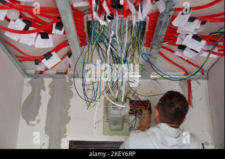 Electrician technician at work on electric installation Stock Photo