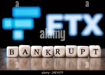FTX is cryptocurrency exchange. Word BANKRUPT made up of cubes on background of FTX logo. Stock Photo