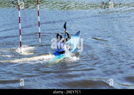 Athlete on a kayak during a rowing slalom competition close-up. Stock Photo