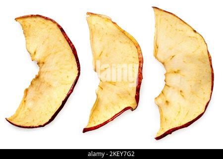 Three dried apple slices isolated on white. Top view. Stock Photo