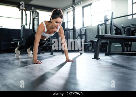 fitness woman performing push - ups from the floor . Stock Photo