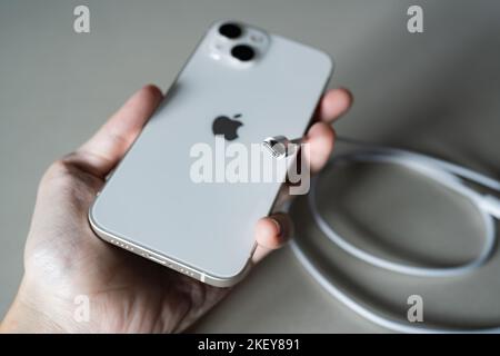 Bangkok, Thailand - October 30, 2022: Apple iPhone 13 and USB-C cable. Stock Photo