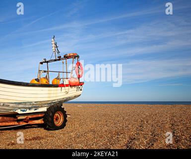 An inshore fishing boat stored on trailer above high water mark on the North Norfolk coast at Cley-Next-the-Sea, Norfolk, England, United Kingdom. Stock Photo