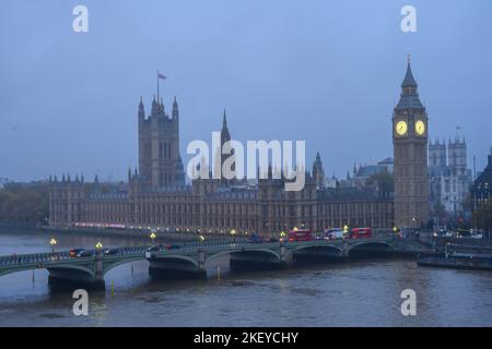 Westminster, London, UK. 15th November 2022. UK Weather: A wet and gloomy start to the day in Westminster with dark, grey skies over the Houses of Parliament. Yellow weather warnings of wet weather are in place in parts of the UK today. Credit: Celia McMahon/Alamy Live News. Stock Photo