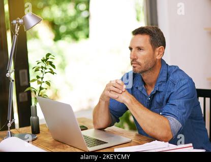 Starting out small from home. a man looking thoughtful while working from home. Stock Photo