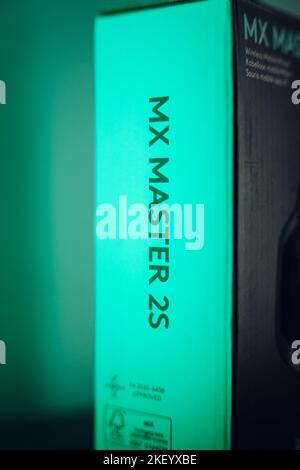 A vertical top closeup of a black mouse from Logitech in the box, MX Master 2S on the green background Stock Photo