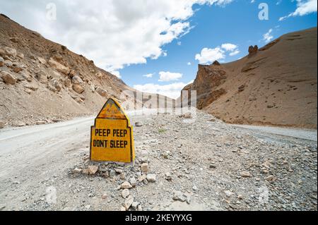 Funny Indian Road sign with copy space on Leh - Manali Highway, unpaved road, travel destination, India Stock Photo