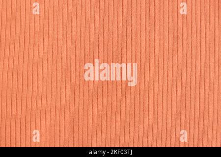 Ribbed cotton fabric texture pastel orange color . Close up rib cotton cloth and textiles pattern. Natural organic fabrics texture background. Stock Photo