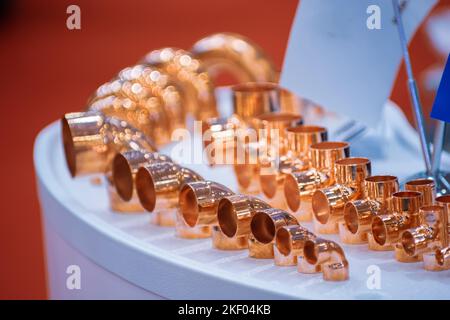 Copper pipe fittings. Set of connecting angle pipes made of copper. Stock Photo