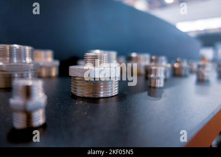 Threaded fittings. Brass nickel-plated fitting. Stock Photo