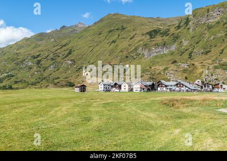 small village in the mountains with stone houses, flowers and a river in val formazza Stock Photo