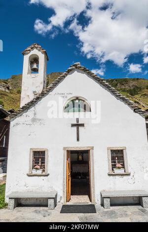 little church on top of the hill in the mountains in Formazza Valley Stock Photo