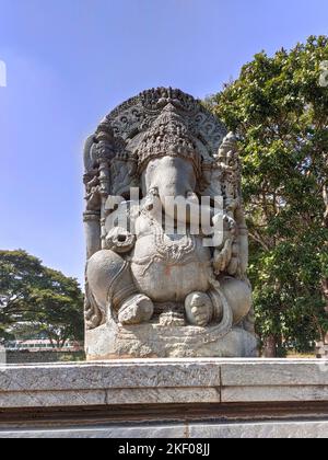 Lord Ganesha sculpture at Halebidu Temple, Karnataka. Depicted seated in a meditative pose with traditional symbols like an axe and sweets. Stock Photo