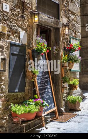 Signboard outside restaurant on Via Giuseppe Maffei in hilltop town of Cortona in Tuscany, Italy Stock Photo