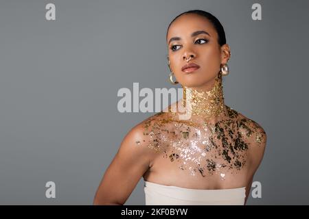 Young african american woman with foil on neck and golden piercing isolated on grey,stock image Stock Photo