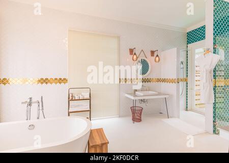 Luxury modern home bathroom interior with bright white cabinets, white marble decor walk in shower, free tub. Luxurious hotel resort interior, elegant Stock Photo
