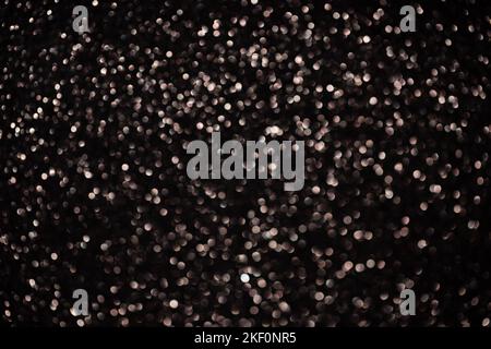 Dark bronze glittering bokeh background. Christmas shiny texture. Stock Photo