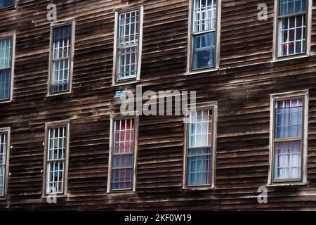 Close up of an weathered old building with rows of windows. Stock Photo