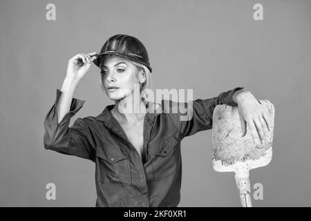 a bit tired. building and construction. lady architect worker. engineer on orange background. Stock Photo