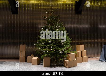 Wrapped gifts under the christmas tree. Presents under the decorated pine tree. Stock Photo