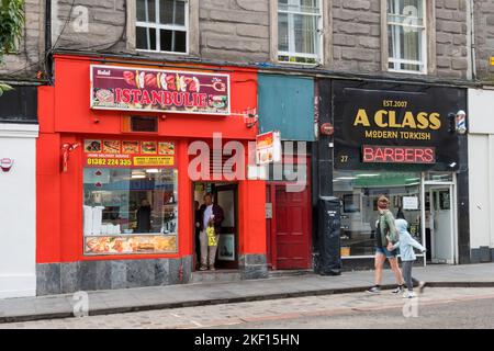 New uses for traditional shops.  Turkish Kebab shop and Turkish Barbers next to each other in Union Street, Dundee. Stock Photo