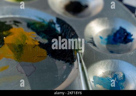 watercolor palette mix of different colors, brushes, paint on paper, mexico Stock Photo