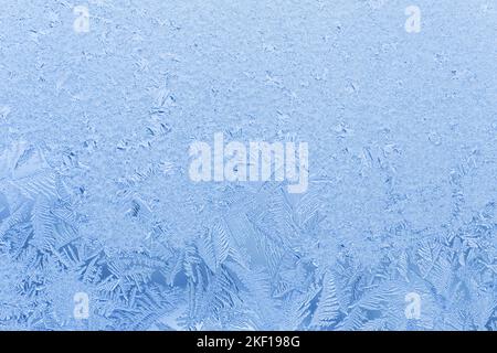 close up of blue frost pattern on frozen window Stock Photo