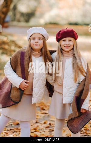 Happy children cuddling in a beautiful autumn park Stock Photo