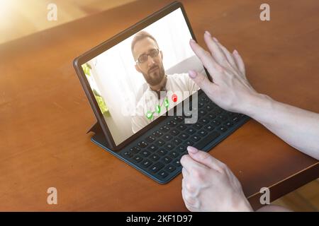 Ask general practitioner online, video call consultation, patient and doctor talk concept. Head shot of mature male therapist share information Stock Photo