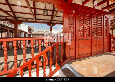 Red wooden structure in the town square Stock Photo
