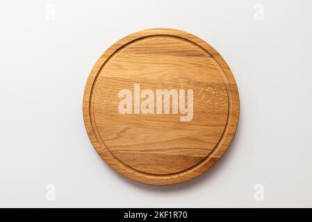 Empty wood round cutting board on white background Stock Photo
