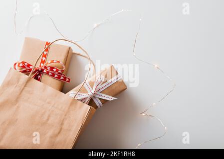 Paper bag from kraft paper with gift and Christmas gift boxes Stock Photo