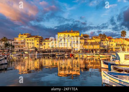 Scenic view of small port of Sanary sur Mer in south of France reflected to Mediterranean sea during colorful winter sunset Stock Photo