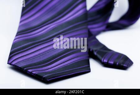 tie in purple and black stripes on white background Stock Photo