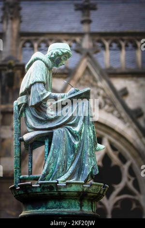 Statue of a writing monk at the medieval Dom cathedral, Utrecht, the Netherlands Stock Photo