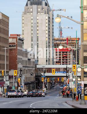 Ottawa, Canada - November 5, 2022: Busy Rideau street in downtown district. Cityscape with intersection, traffic lights, and walking people. Stock Photo