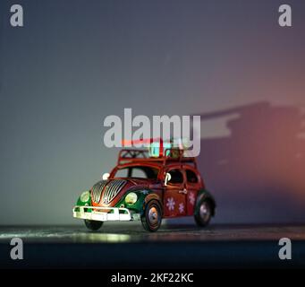 A small metal retro Christmas car with a gift box. Gift delivery concept Stock Photo